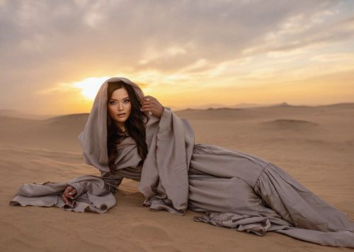 Lady in abaya on Dubai desert sand photographed by top professional photographers.